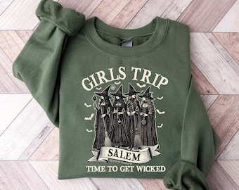 May include: Green sweatshirt with a graphic of four witches and the text "Girls Trip Salem Time to Get Wicked".