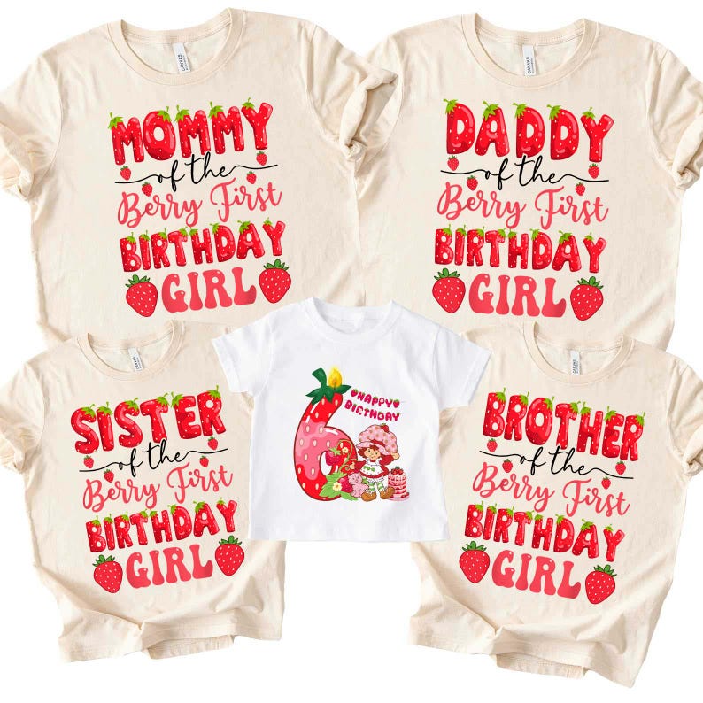 May include: A collection of matching family birthday shirts. The shirts are cream-colored and white, with red and pink text that reads "Mommy", "Daddy", "Sister", and "Brother" with "of the Berry First Birthday Girl". A smaller white shirt has a strawberry graphic.