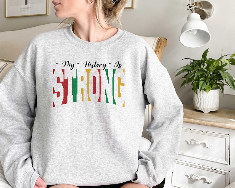 May include: Grey sweatshirt with the text "My History Is Strong" in colourful letters. The letters are outlined in black and have a vintage look.