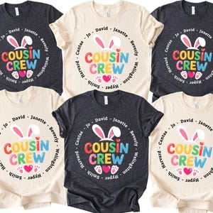 May include: Six t-shirts in different shades, each displaying a vibrant "Cousin Crew" design. The design incorporates bunny ears, hearts, and names in a circular arrangement. Ideal for family events and reunions.
