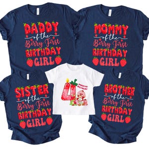 May include: A collection of navy blue t-shirts and a white t-shirt with strawberry-themed birthday graphics. The navy shirts read "Daddy," "Mommy," "Sister," and "Brother" with "of the Berry First Birthday Girl." The white shirt has a "4" and a Strawberry Shortcake graphic.