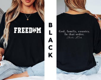 May include: Black t-shirt with the word "FREEDOM" in bold white letters and a portrait. The back of the shirt displays the text "God, family, country. In that order." and a signature.