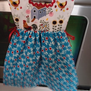 Pioneer Woman  Sweet Rose Towel with a Chicken farm scene top hangs on oven door