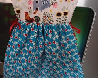 Pioneer Woman  Sweet Rose Towel with a Chicken farm scene top hangs on oven door