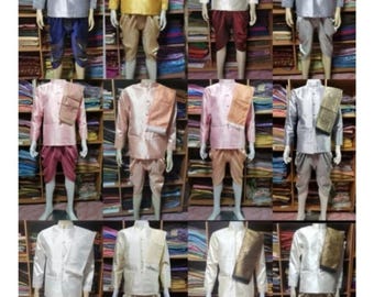 May include: A display of traditional Thai clothing for men. The clothing is made of silk and comes in a variety of colors, including gold, pink, white, and blue. The clothing is displayed on mannequins in a shop setting.