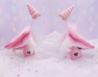 Pink cow ears on a metal headband