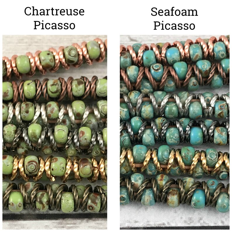 May include: Close-up of two strands of multi-colored beads. The beads are green and brown with white flecks, and turquoise and brown with white flecks. The beads are arranged in a pattern of alternating colors. The text "Chartreuse Picasso" and "Seafoam Picasso" is above each strand of beads.