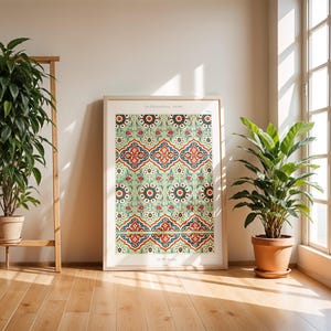May include: A framed print of a vintage illustration of a decorative tile pattern. The tile pattern is a repeating design of green, red, blue, and white geometric shapes. The title of the print is "La Decoration Arabe" and the text "19th Century" is below the title.