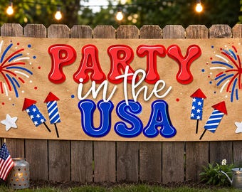 May include: A tan banner with the words "PARTY in the USA" in red and blue, decorated with fireworks, stars, and rockets. The banner is hanging on a wooden fence, with string lights in the background.