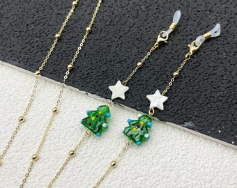 Kerstboom en sterhanger glazen ketting, dameszonnebril touw, cadeaus