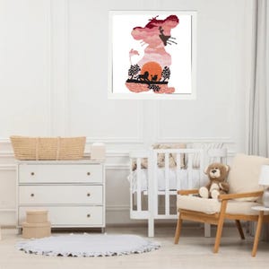 Op de afbeelding: Een ingelijste print van een leeuwen-silhouet met een zonsondergang-achtergrond. De leeuw kijkt naar rechts en heeft een manen. De zonsondergang is een gradiënt van oranje, roze en paars. Op de voorgrond zijn drie kleinere leeuwen-silhouetten te zien.