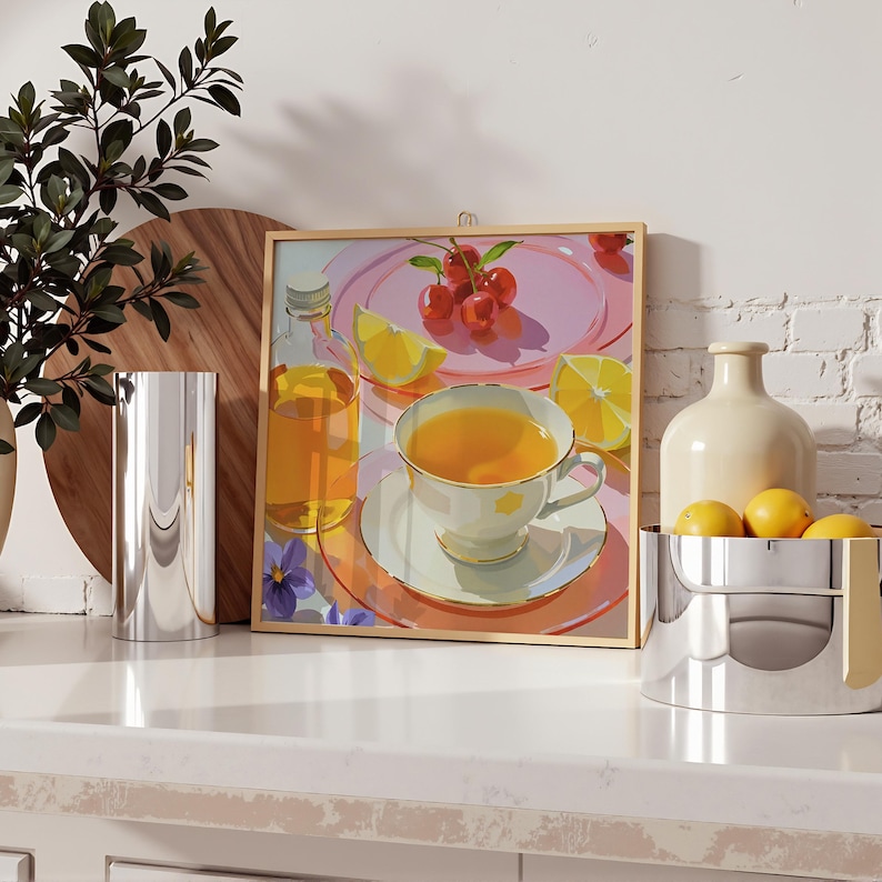 May include: A framed print of a still life with a teacup, cherries, and lemons. A silver vase and a bowl of lemons are on the counter. A bottle of liquid is next to the print. The color palette is soft and pastel.