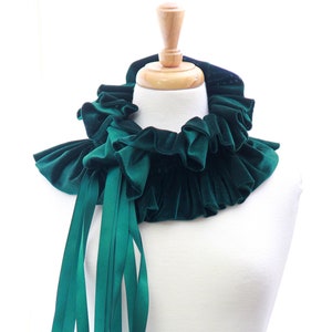 May include: A deep green velvet choker with ruffled edges and long satin ribbon ties.