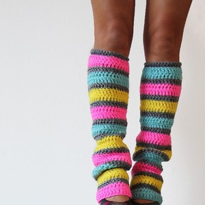 May include: A pair of colorful striped leg warmers in pink, yellow, and blue. The leg warmers are crocheted and have a textured look.