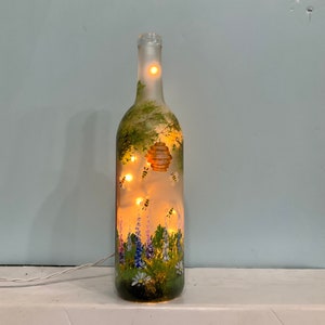 Garden with bees wine bottle light plug in it battery