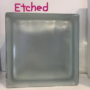 May include: A frosted glass block with the word "Etched" written above it.