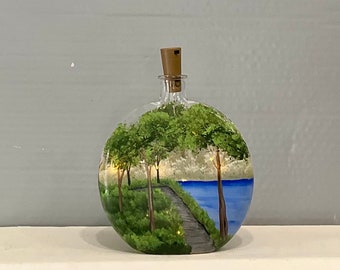 Bottle  with fairy lights hand painted glass walkway by lake