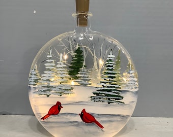 Bottle painted light winter scene birch and fur trees and cardinals in snow