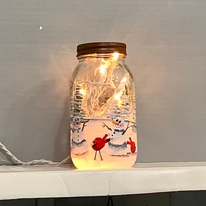 Mason jar light snowmen with cardinals