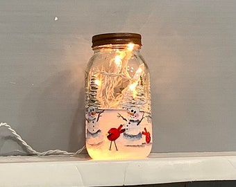 Mason jar light snowmen with cardinals