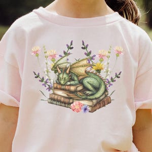 Dragon Lover Kids Tee  Cute Book & Flowers Shirt for Young Readers  Gift for Girls Who Love Dragons and Books Youth T-Shirt Unique Kids Tee