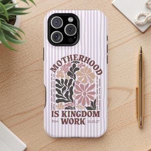 May include: A phone case with a vertical striped pattern in white and lavender. The case features the text "MOTHERHOOD IS KINGDOM WORK" in a floral design. The Bible verse Proverbs 31:25-27 is also included.