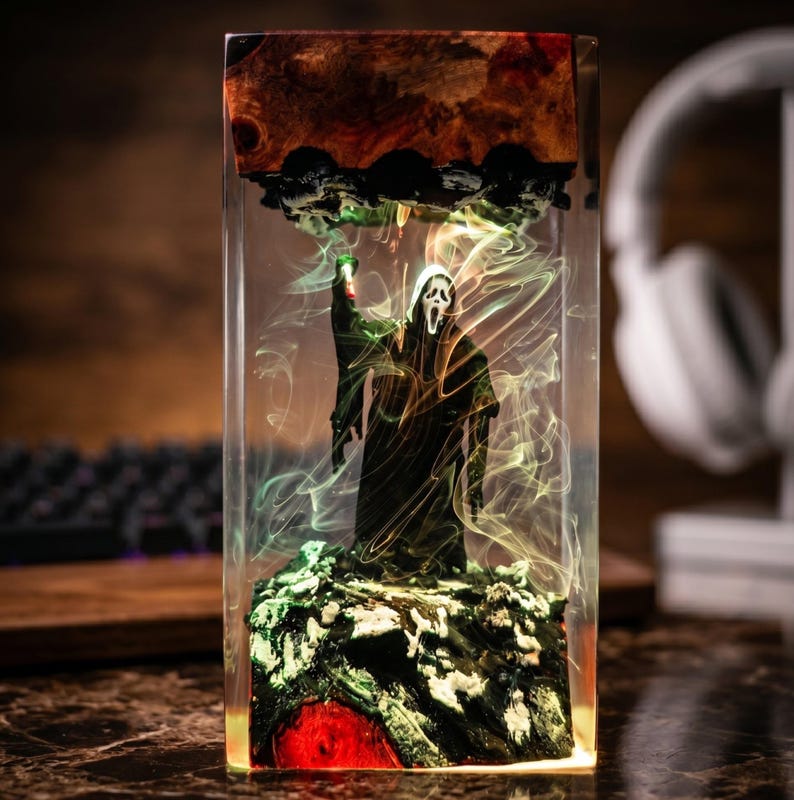 K&ouml;nnte beinhalten: Ein rechteckiges Kunstwerk aus Harz mit einer Scream-Figur. Die Figur ist schwarz und steht auf einem gr&uuml;nen und roten Sockel mit wirbelnden gelben und gr&uuml;nen Akzenten. Der obere Teil hat ein dunkelbraunes Holzmaserungsdesign.