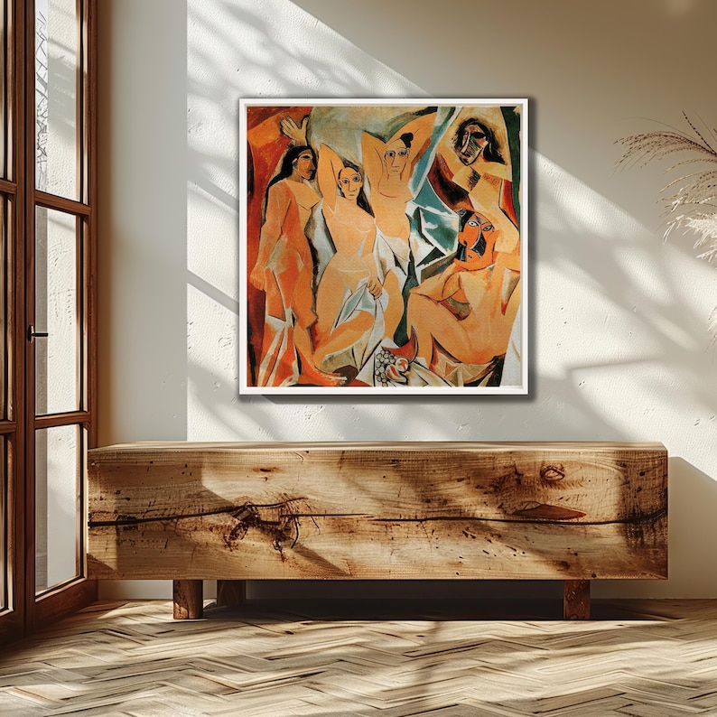 Puede incluir: Una pintura abstracta enmarcada que presenta figuras desnudas en tonos naranja, beige y azul. La obra de arte se exhibe en una pared blanca sobre un mueble de madera. La pintura tiene un borde blanco.