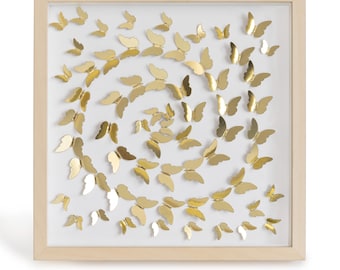 May include: A framed wall art piece featuring a swirling pattern of gold butterflies on a white background.