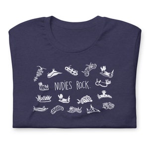 May include: A navy blue t-shirt with a white graphic of various sea slugs and the text "NUDIES ROCK."