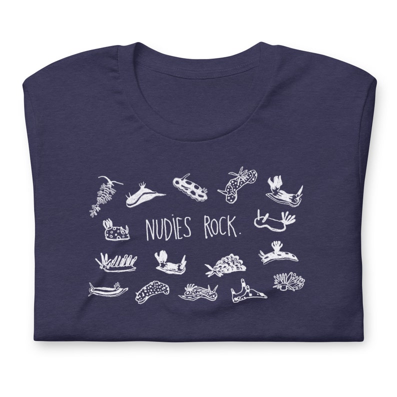 May include: A navy blue t-shirt with a white graphic of various sea slugs and the text "NUDIES ROCK."