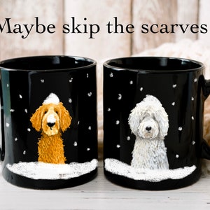 May include: Two black coffee mugs with white snow and snowflakes on them. Each mug features a dog wearing a white hat. One dog is brown and the other is white.