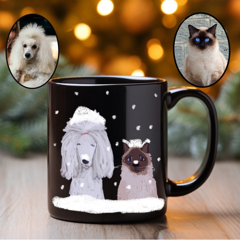 May include: Black ceramic coffee mug with a white poodle and a white cat with blue eyes on a snowy background. The mug has a white handle.