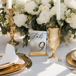 Gold Mirror Table Numbers for Weddings and Events on a White table with gold accents and white flowers