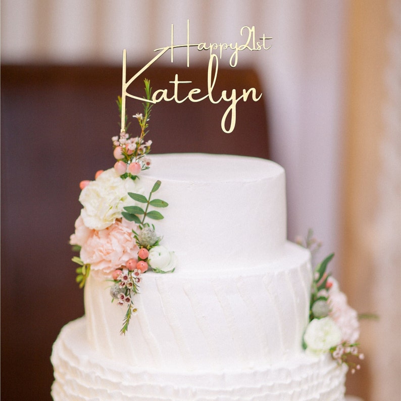 Personalized happy 21st Cake Topper in Gold on a white tiered cake with pale pink flowers