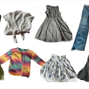 May include: A collection of clothing items including a black satin top, a white crocheted top, a gray linen dress, a rainbow striped sweater, a green button-down shirt, a white floral skirt, a black skirt, and a pair of blue jeans.