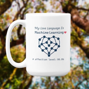 Puede incluir: Taza de cerámica blanca con asa curva. La taza presenta el texto "My Love Language Is Machine Learning" sobre un gráfico azul en forma de corazón. Debajo del gráfico está el texto "# affection level: 99.9%."