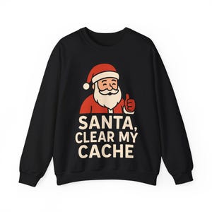 May include: Black sweatshirt with a Santa Claus graphic giving a thumbs up. The Santa illustration is in red and white, with the text "SANTA, CLEAR MY CACHE" in white letters.