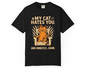 May include: Black t-shirt with a graphic of an orange cat sitting on a throne, with the text "MY CAT HATES YOU. AND HONESTLY...SAME." The cat has an angry expression and is wearing a crown.