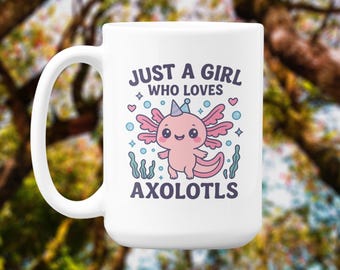 May include: White ceramic mug with a playful design. The mug displays the text "JUST A GIRL WHO LOVES AXOLOTLS" above a cartoon axolotl illustration in pink, blue, and white. The axolotl wears a party hat and is surrounded by hearts and bubbles.