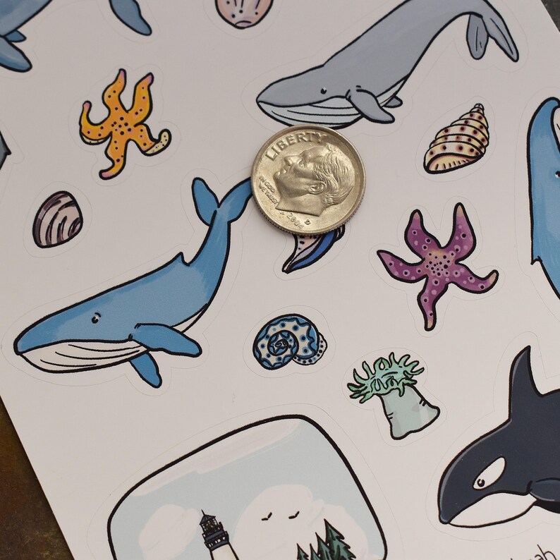 May include: A sheet of stickers featuring various ocean-themed illustrations, including whales, starfish, seashells, and a lighthouse. The stickers are printed on white paper and are perfect for adding a touch of whimsy to any project.