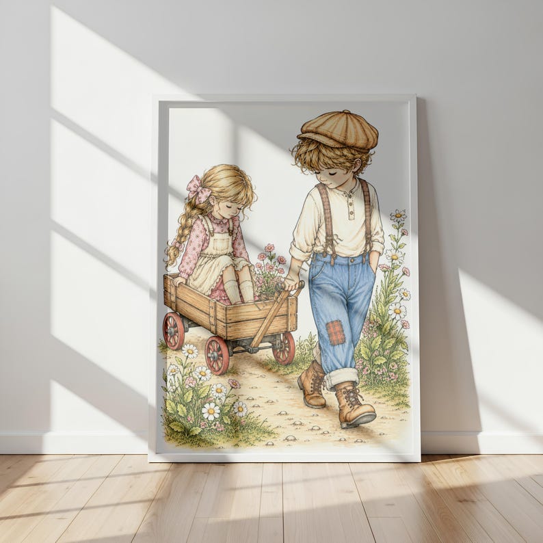 May include: A framed illustration of a child in a tan cap, white shirt, and blue jeans pulling a wooden wagon. Inside the wagon sits another child with long blonde hair wearing a pink patterned dress and white pinafore, surrounded by wildflowers.