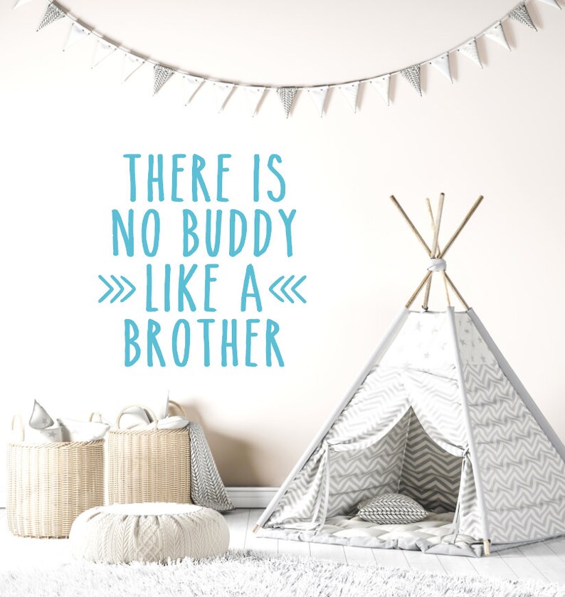 May include: A white teepee tent with a gray and white chevron pattern. The tent is set up in a room with a white rug and a white wall. The wall has a blue and white wall decal that reads "There is no buddy like a brother".