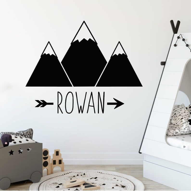 May include: Black and white mountain range wall decal with the name "ROWAN" and an arrow pointing to the right.