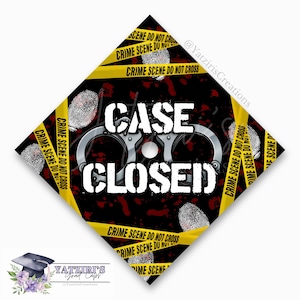 May include: A black and yellow graduation cap with the text "CASE CLOSED" in white. The cap is decorated with handcuffs, fingerprints, and yellow crime scene tape.