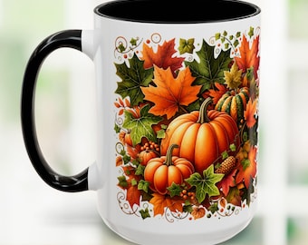 May include: White ceramic mug with a black handle and interior. The mug features a vibrant autumn design with orange pumpkins, fall leaves, and berries. The design is set against a white background.