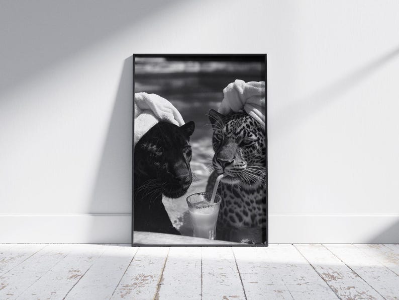 May include: Black and white photo of two leopards wearing white towels on their heads, sitting next to each other and drinking from a glass with a straw.