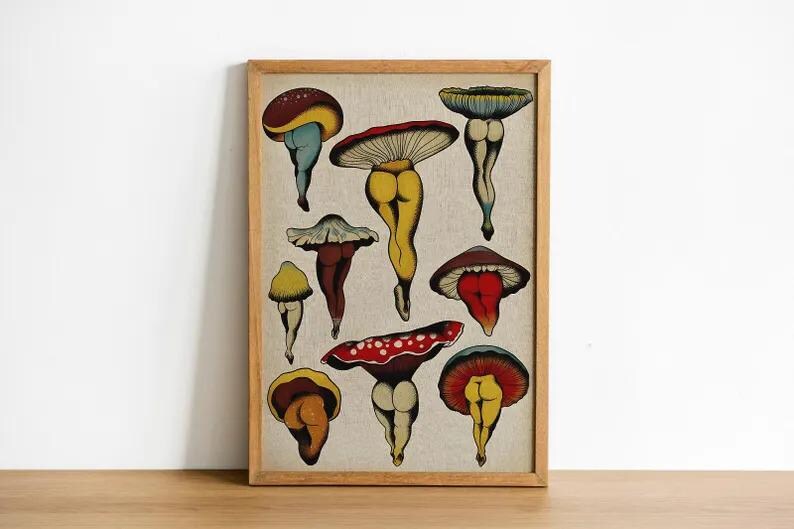 May include: A framed print featuring whimsical mushroom illustrations. The mushrooms have colorful caps and are depicted with human-like legs. The artwork is set against a neutral background and framed in a wooden border, creating a unique and playful aesthetic.