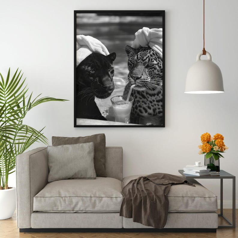 May include: Black and white photo of two panthers wearing white towels on their heads, sitting next to each other and drinking from a glass with a straw.