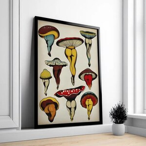 May include: A framed art print featuring whimsical mushroom illustrations. The mushrooms have colorful caps and legs, with a playful, artistic style. The print is displayed in a black frame, adding a modern touch to the artwork. The overall theme is nature-inspired art.